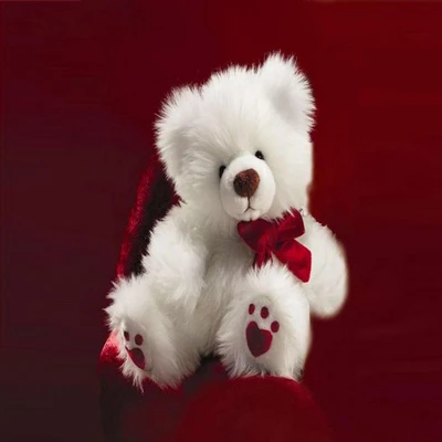 Adorable white teddy bear with a red bow, set against a rich red background.