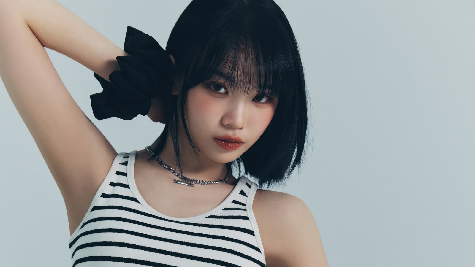 A close up of a woman with a black and white striped top (le sserafim, 르세라핌, kpop, korean, girl group)