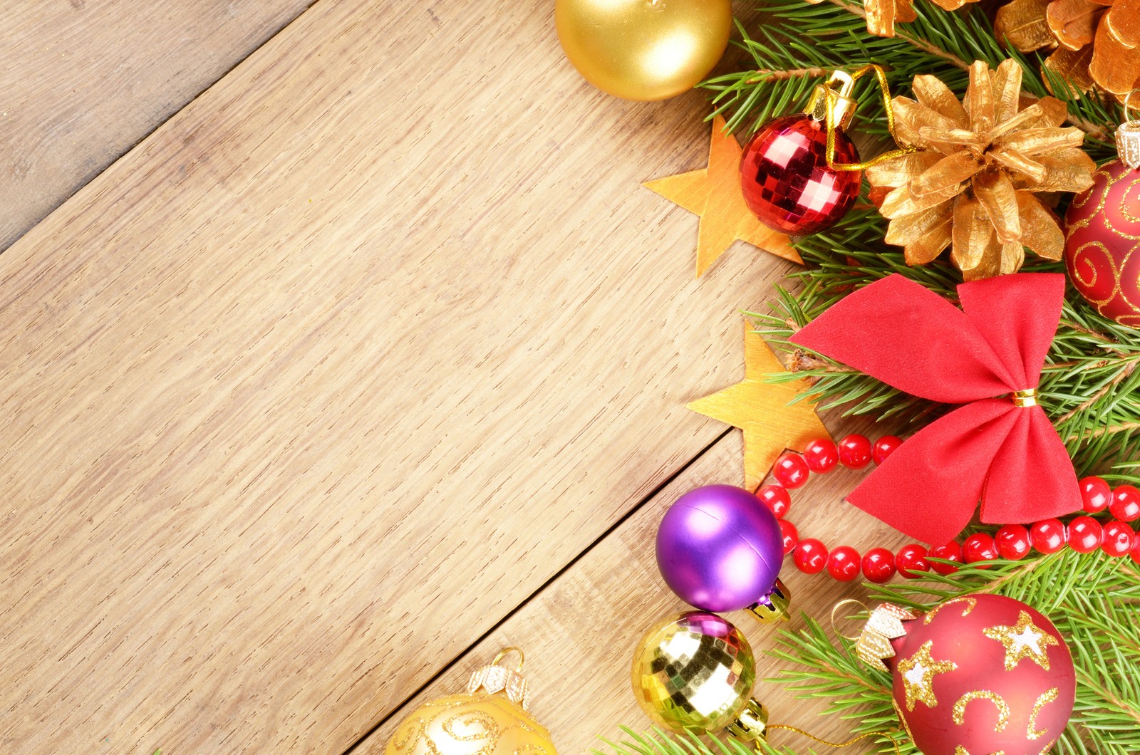 Decorações de natal em uma mesa de madeira com um laço vermelho. (enfeite de natal, árvore de natal, véspera de natal, natal, presente)