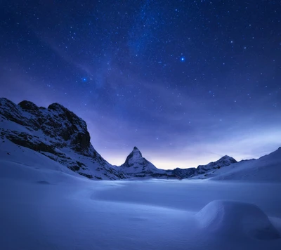 Noite de inverno estrelada sobre montanhas cobertas de neve