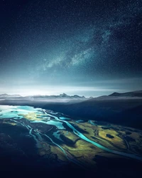 Majestic Aerial View of Mountain Landscape Under a Starry Night Sky