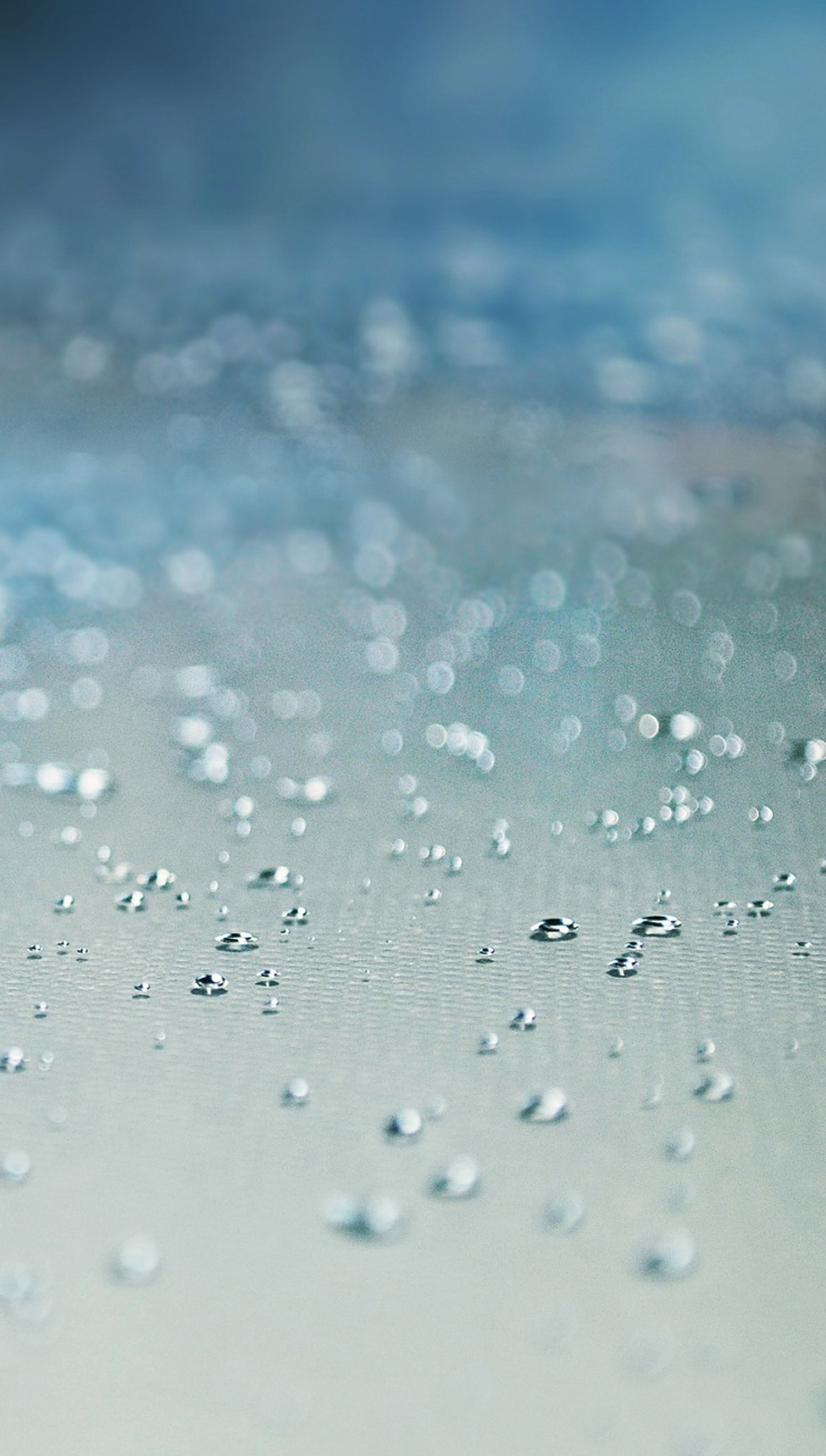 Un gros plan d'une surface humide avec des gouttes d'eau dessus (abstrait, photo)