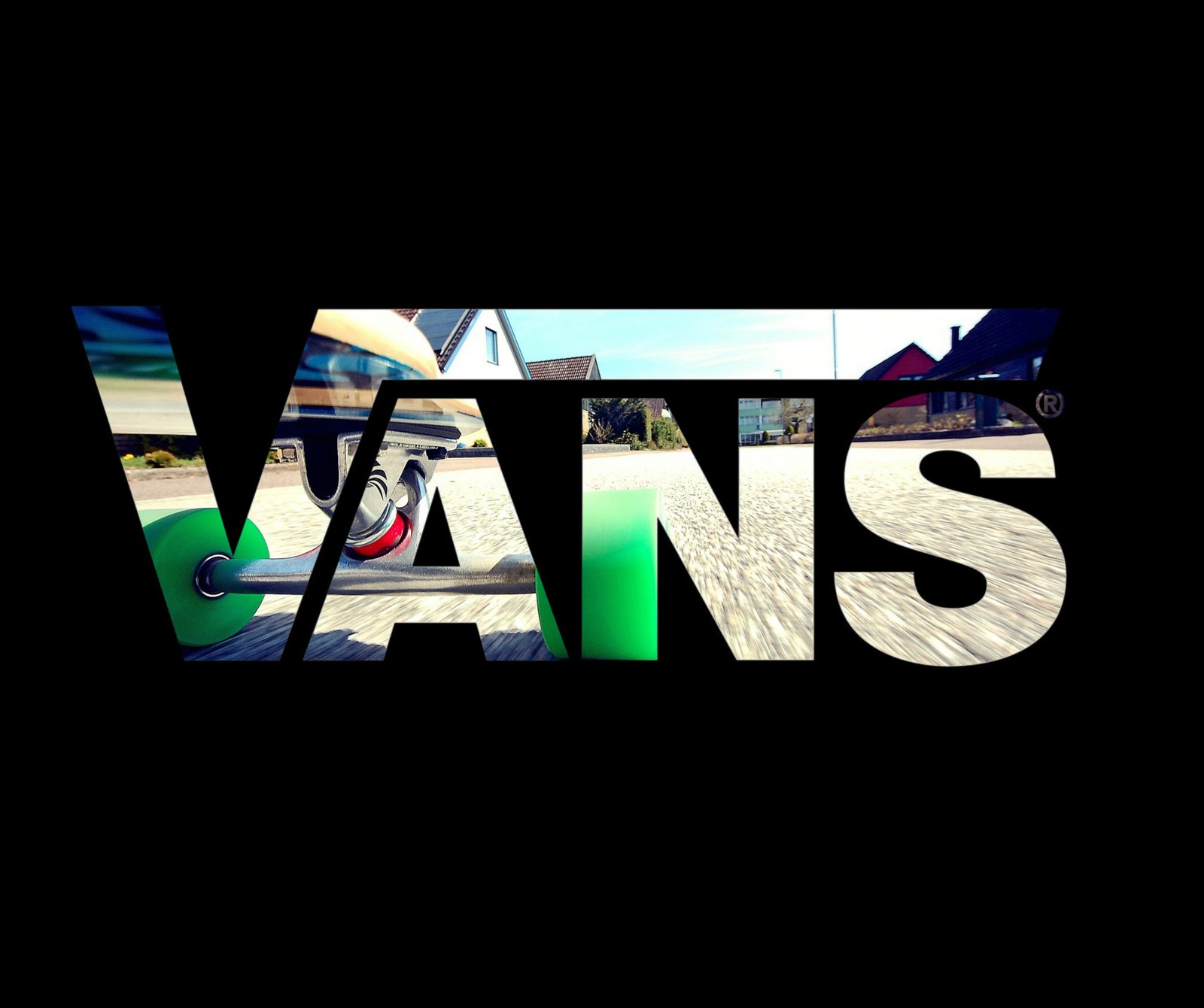 A close up of a skateboarder riding down a street with the word vans written in it (brand, logo, skate, vans)