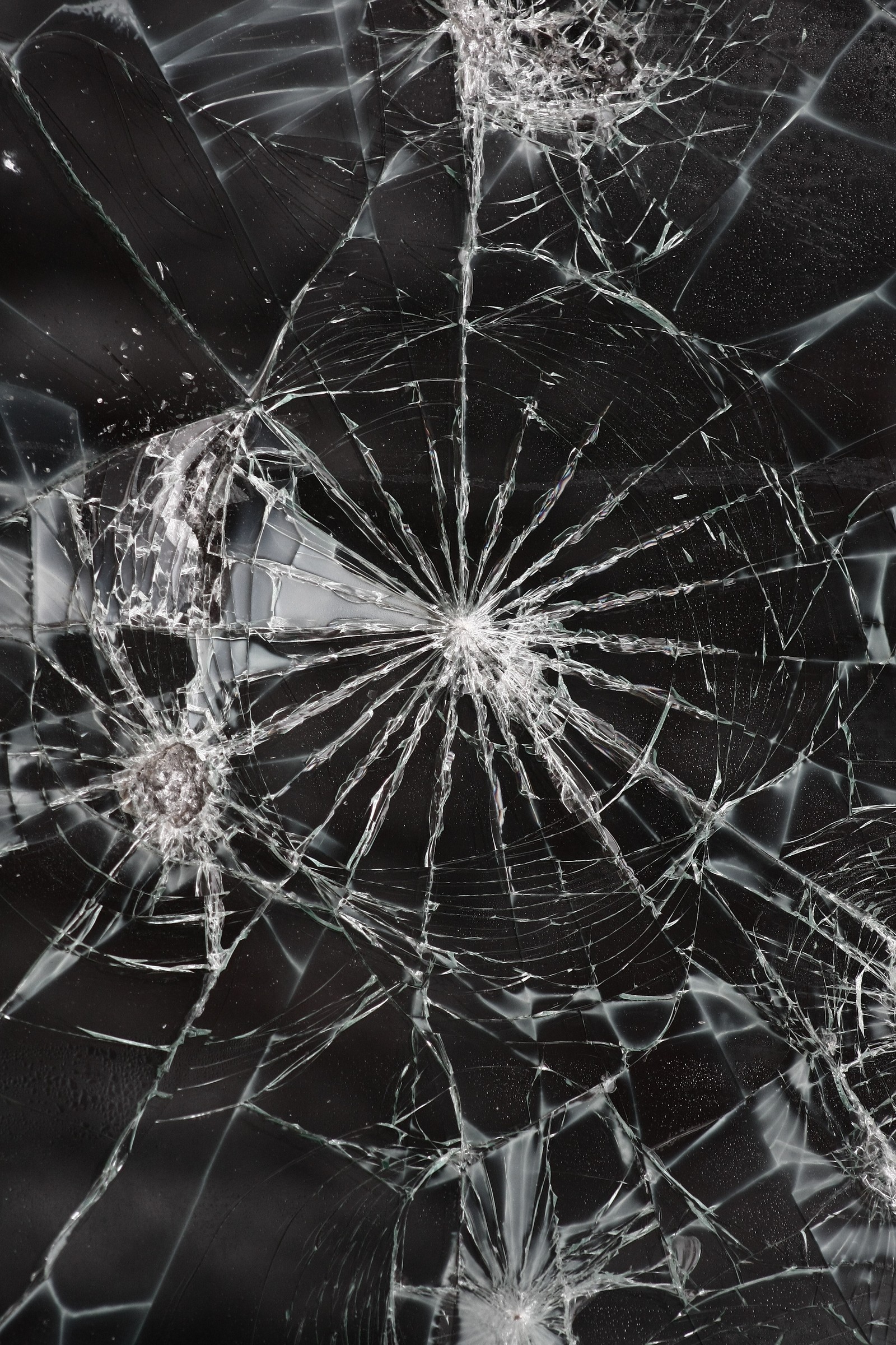 A close up of a broken glass window with a black background (abej, beograd, broken, cracked, glass)