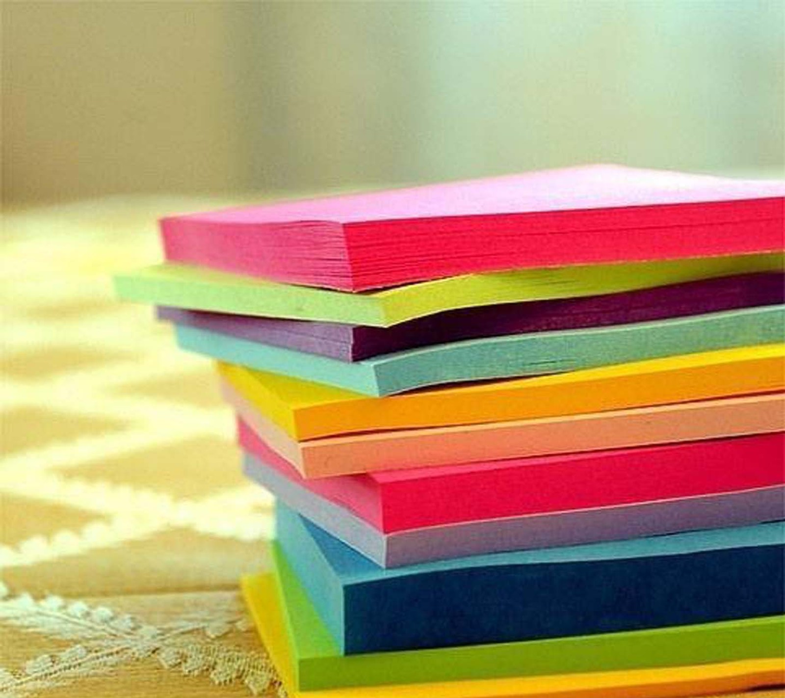 Brightly colored post it notes stacked on top of each other (comment, rate my upload i)