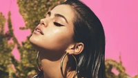 Selena Gomez Radiates Confidence Against a Vibrant Pink Background