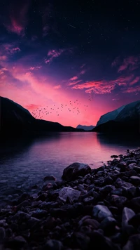 Serene Sunset Reflection over Rocky Shoreline