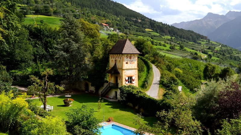 A view of a small house with a pool in the middle of a lush green valley (mountain village, nature, estate, mount scenery, plant)