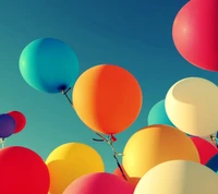 Colorful Balloons Ascending into a Clear Sky