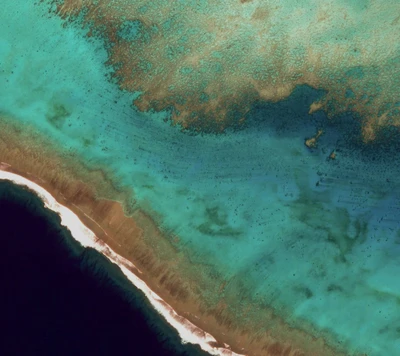 Aerial view of vibrant turquoise waters and sandy shores.