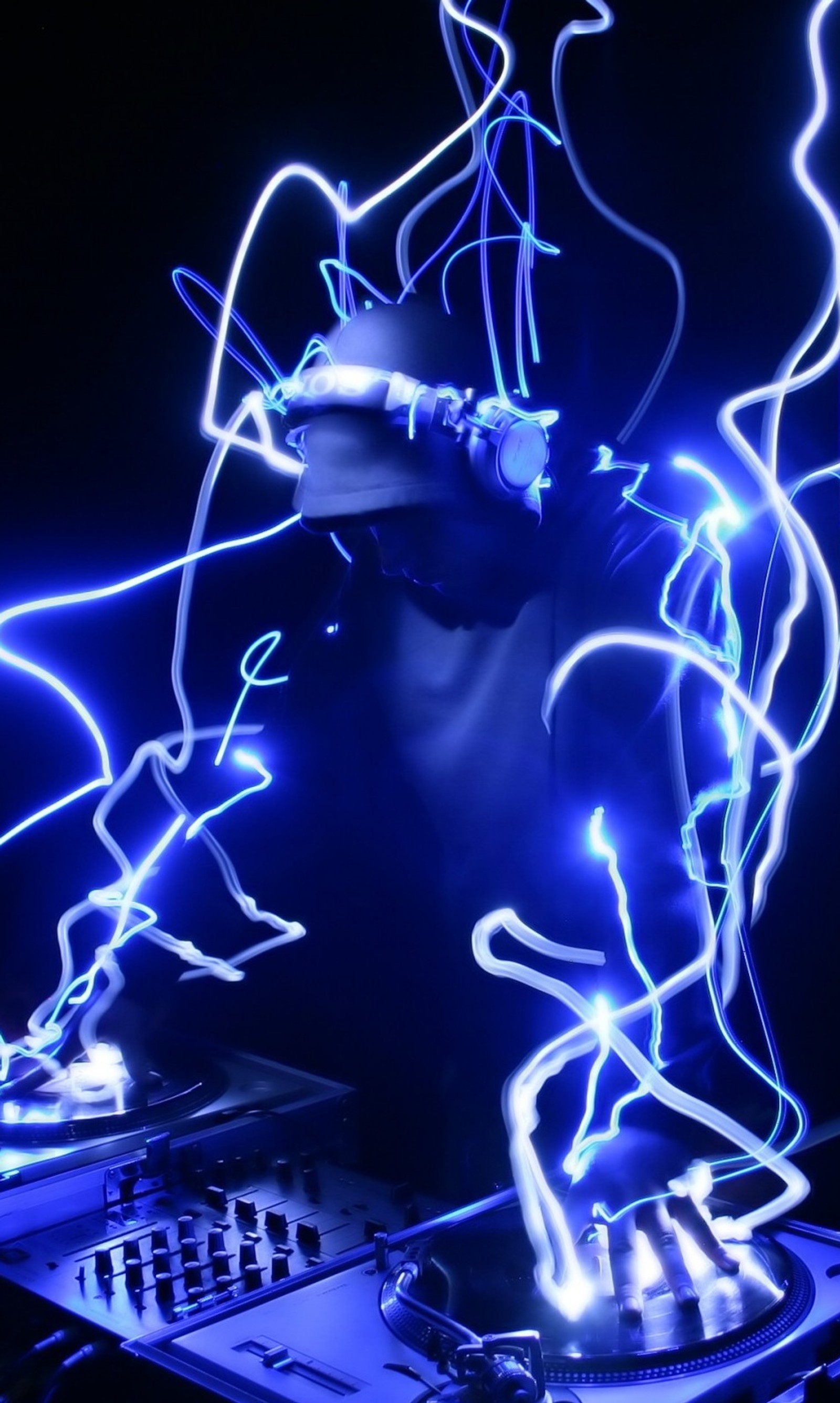 Arafed image of a dj playing music with a blue light (dj, man)