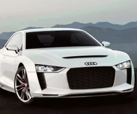 Sleek White Audi Sports Car against a Mountainous Backdrop