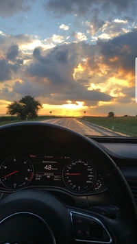 Fahren eines Audi RS7 in einen atemberaubenden Sonnenuntergang