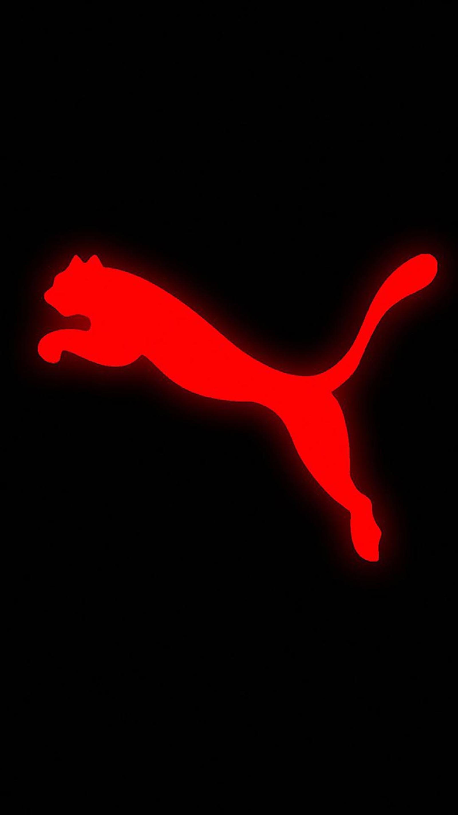 A close up of a red puma logo on a black background (marchio, sport)