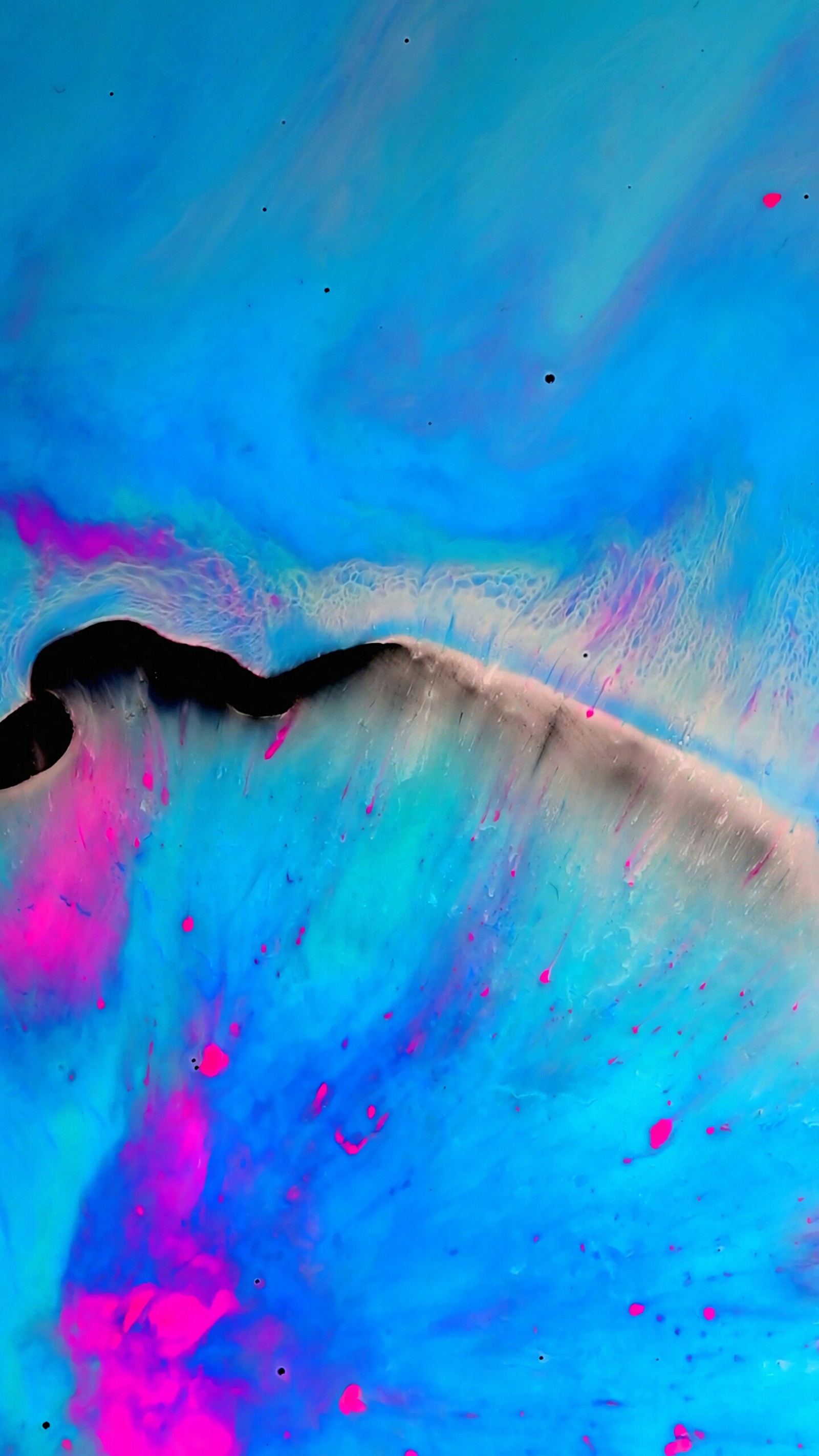 A close up of a blue and pink liquid with a black object (abstract, blue, pink, s7, s8)