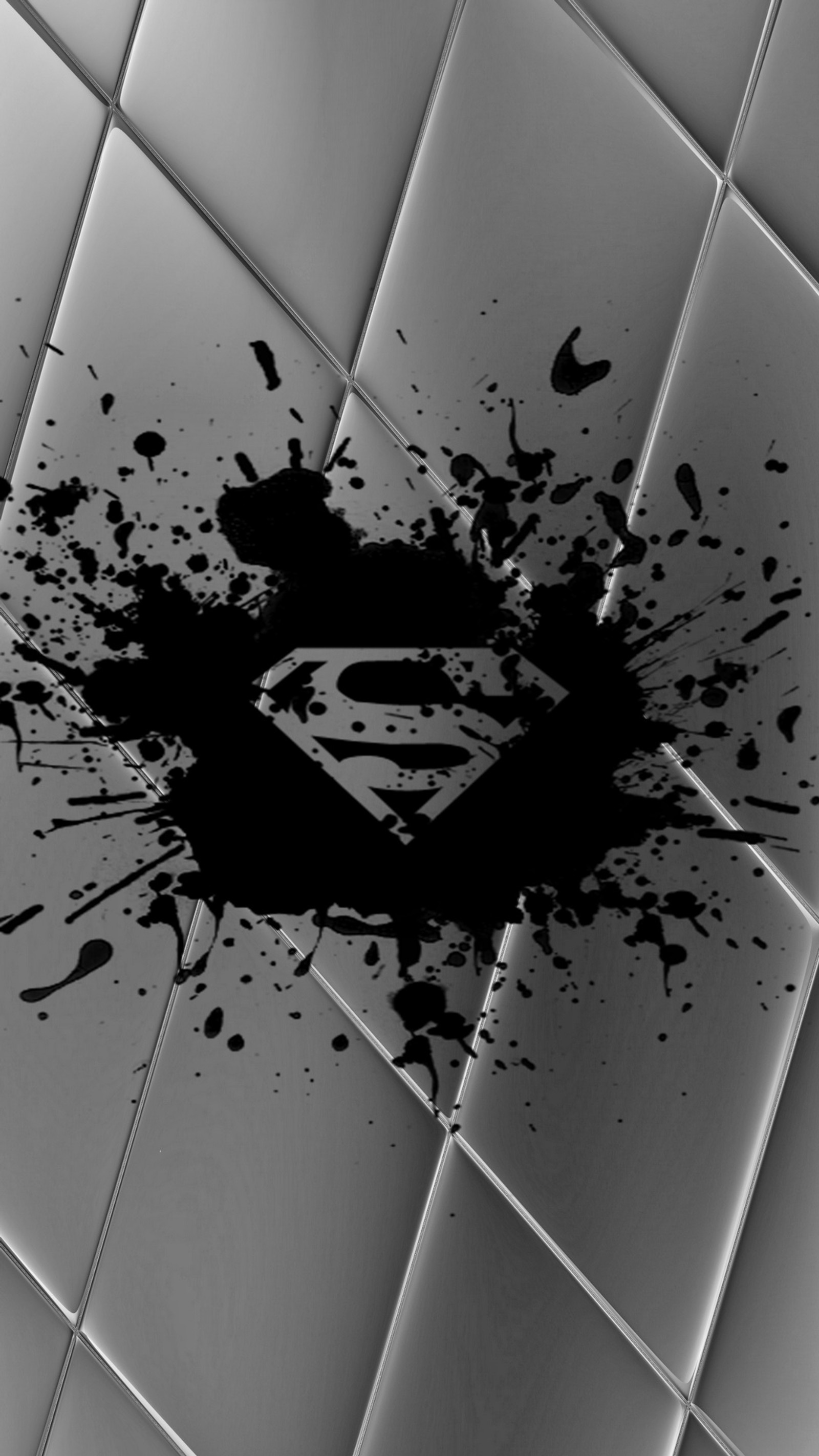 A close up of a black and white photo of a tile floor (black, colors, logo, superman, tiles)