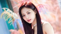 Tzuyu from TWICE posing elegantly with vibrant colors in the background.