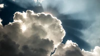 Luz solar radiante de la mañana rompiendo a través de nubes cúmulos