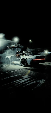 Porsche 959 racing on asphalt at night, showcasing its sleek design and dynamic performance with smoke billowing from the tires.