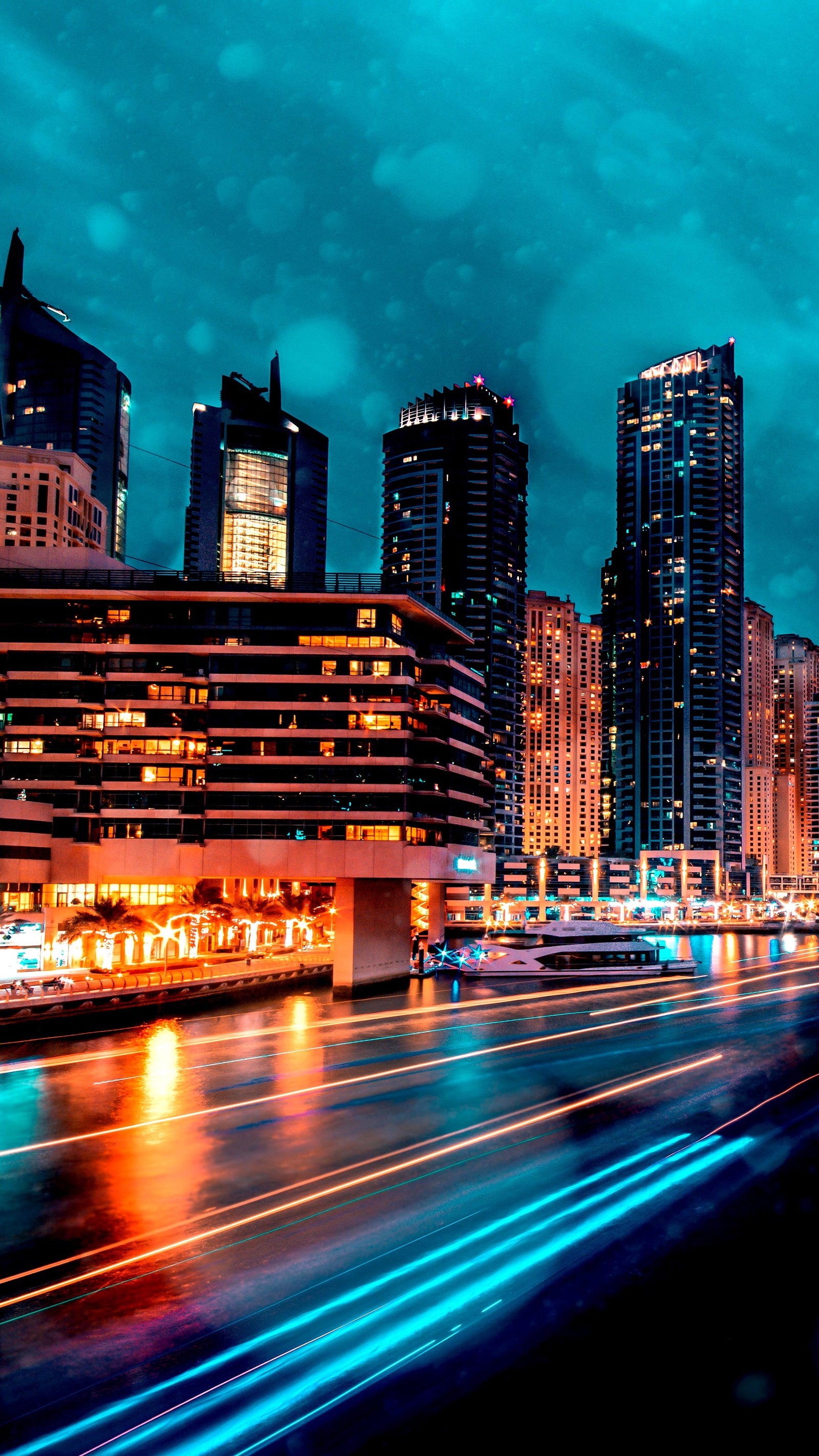 Nighttime view of a city with a river and a bridge (skyscraper, city, dubai, building, cloud)