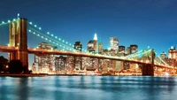 Puente de Brooklyn iluminado: Una vista nocturna del horizonte de la ciudad de Nueva York