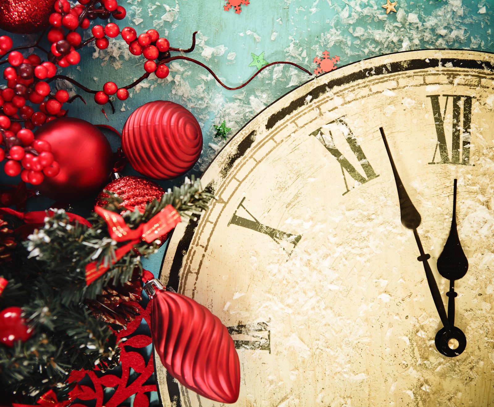 Clock with red decorations and ornaments around it on a blue background (new year, christmas day, new years eve, christmas ornament, holiday)