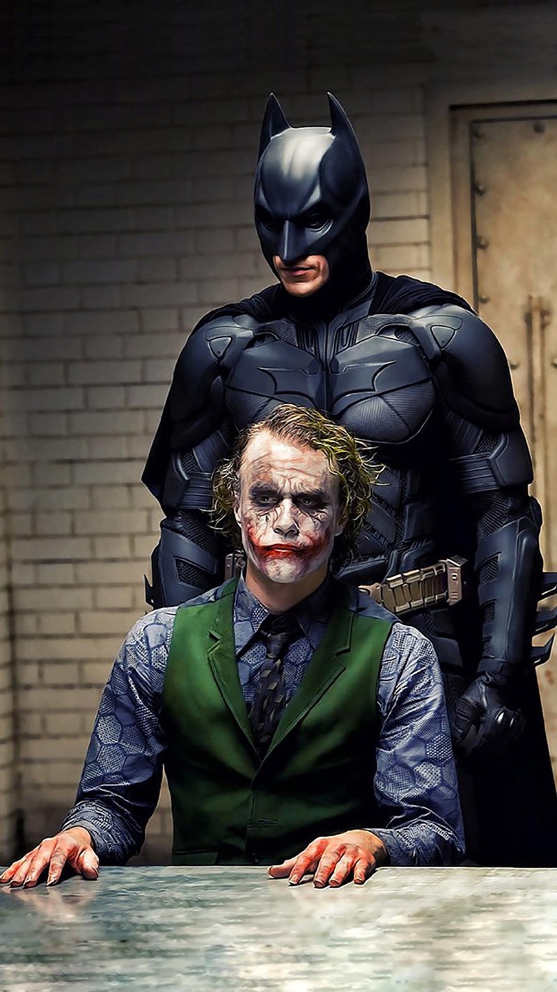 Batman and joker posing for a photo in a dark room (film, knight)