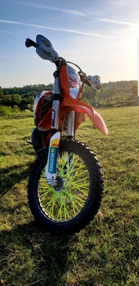 KTM 250 EXC Enduro Motorcycle in an Orange Sunset Landscape