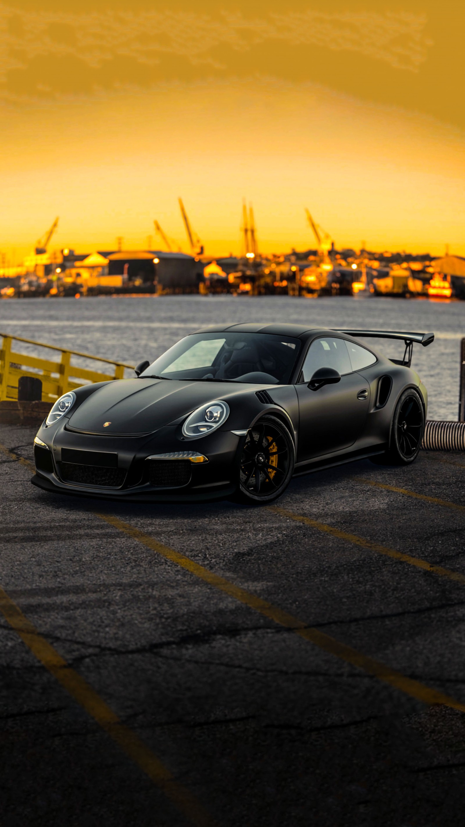 Arafed black sports car parked in a parking lot near a body of water (car, gtr, new, porsche, power)