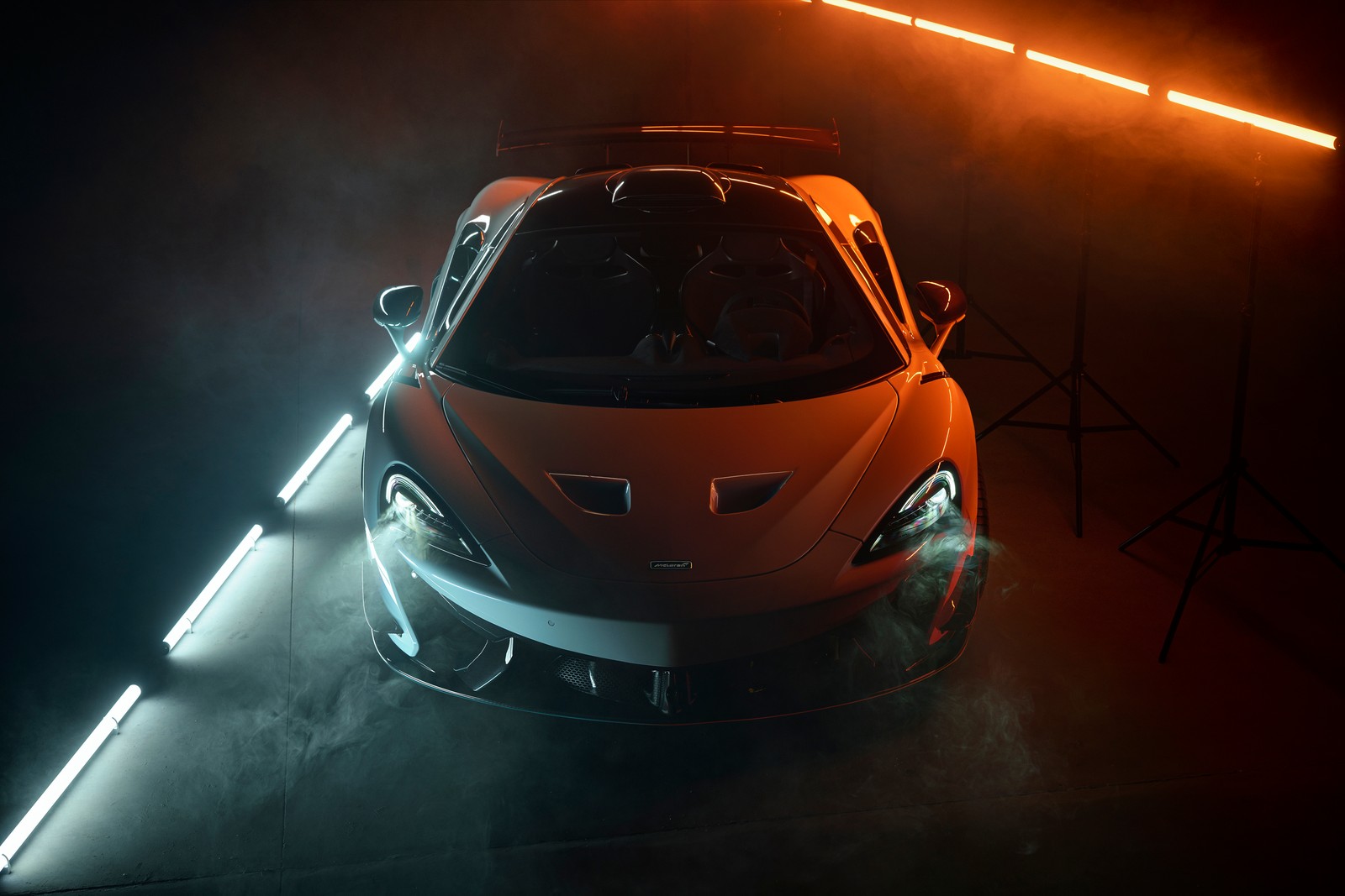 A close up of a car in a dark room with lights (mclaren 620r, novitec, 8k, 2021, 5k)