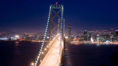 Ponte da Baía de Oakland iluminada contra o horizonte noturno de São Francisco