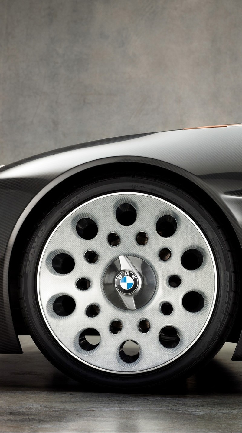 A close up of a car with a lot of holes on the rim (car, love, nice)