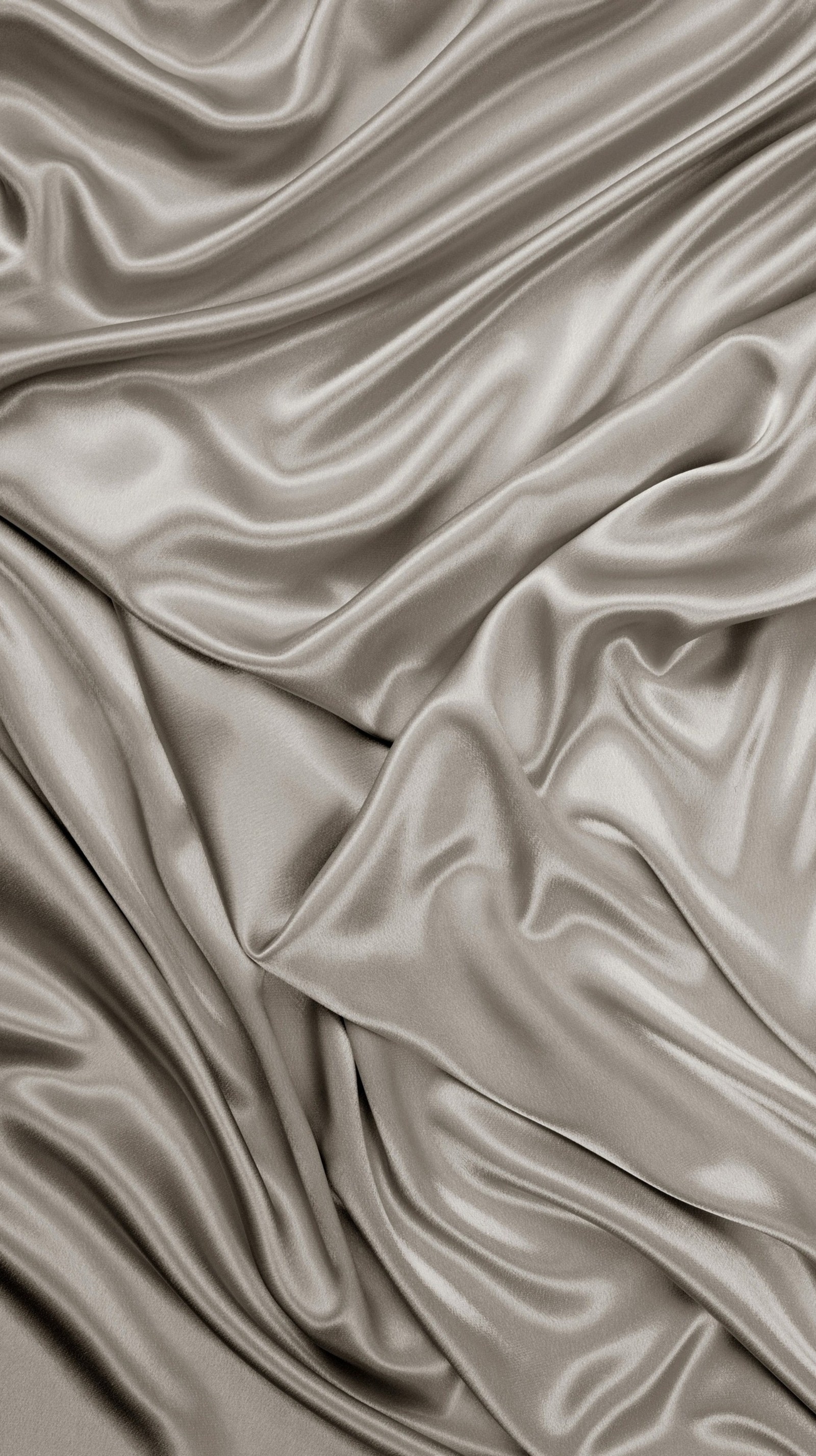 A close up of a bed with a silver colored sheet (design, satin, skin, texture)