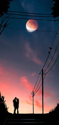 Silhouette of a Couple Embraced Under a Lunar Afterglow