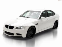 White BMW M3 E90 with sleek body kit and black rims, showcasing a modern luxury automotive design.