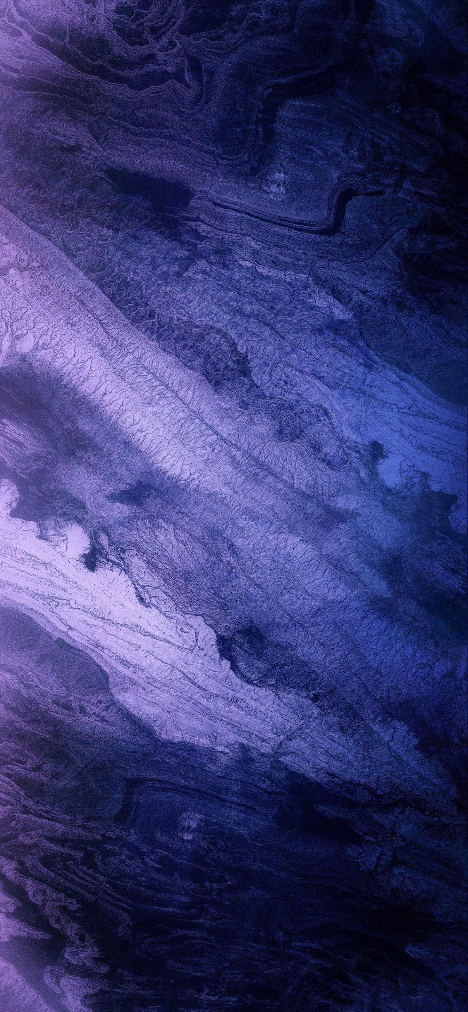 Vue d'un avion survolant une zone rocheuse (ios, violet, gris, bois, bleu électrique)