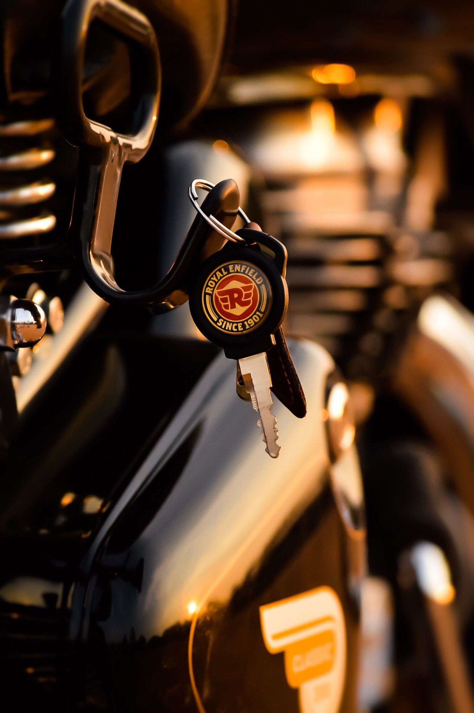 There is a close up of a motorcycle with a bunch of keys (enfield, royal, speed)