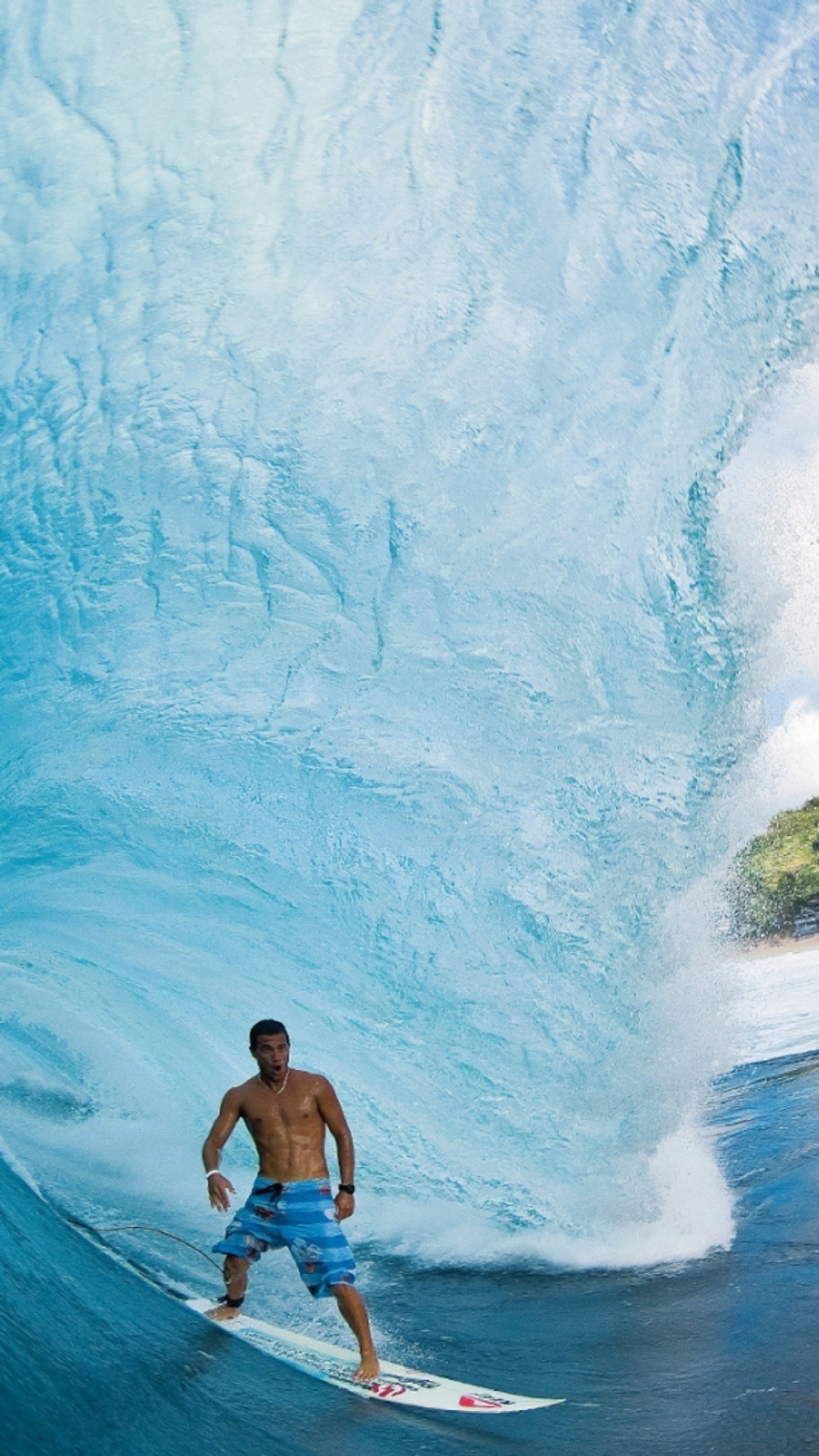 Surfeur en shorts bleus chevauchant une grande vague dans l'océan (plage, bleu, amour, nature, océan)