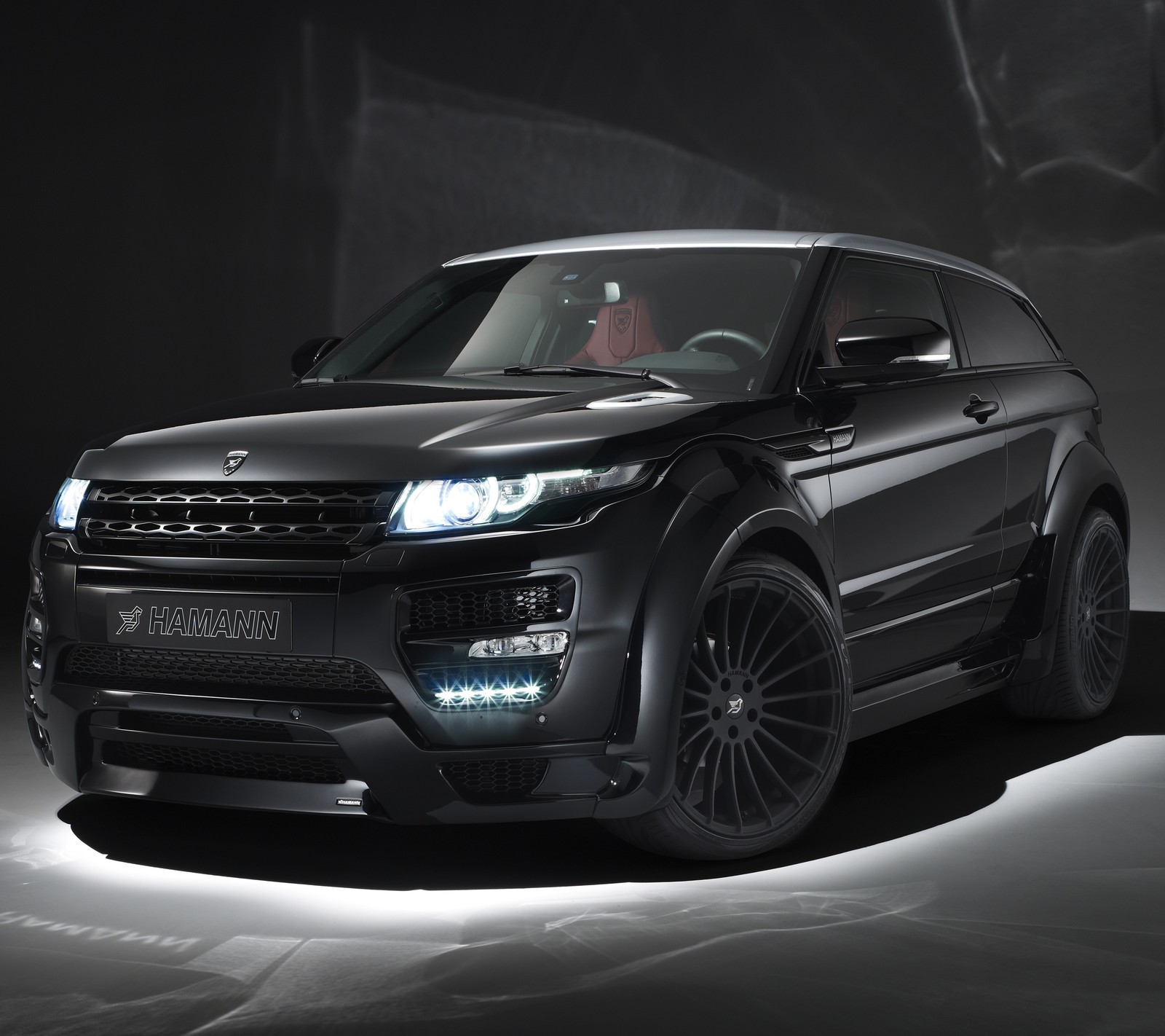 A close up of a black range rover parked in a dark room (auto, car, evoque, range rover, suv)