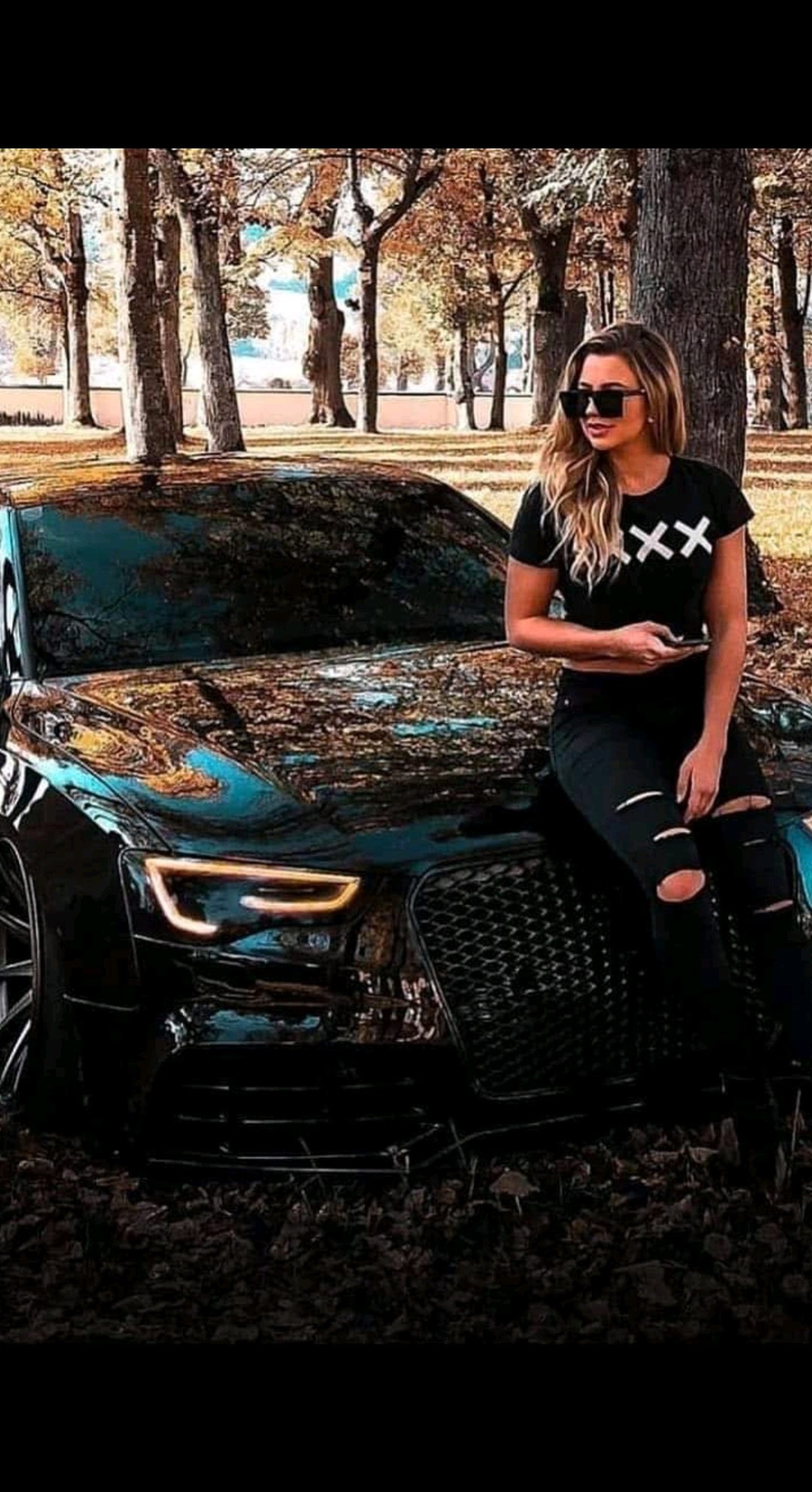 Araffe sitting on a car in the woods with a girl (audi s5, challenger)