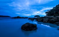 Serenidade do crepúsculo na praia de Kata: uma costa rochosa abraçada pelo oceano