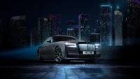 2021 Rolls Royce Ghost Black Badge Illuminated Against a City Skyline at Night