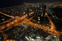 Nighttime Cityscape of Dubai Featuring the Iconic Burj Khalifa