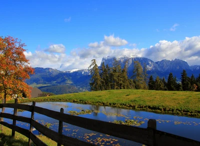 Paysage scénique tranquille avec des montagnes, des arbres et un ruisseau réfléchissant