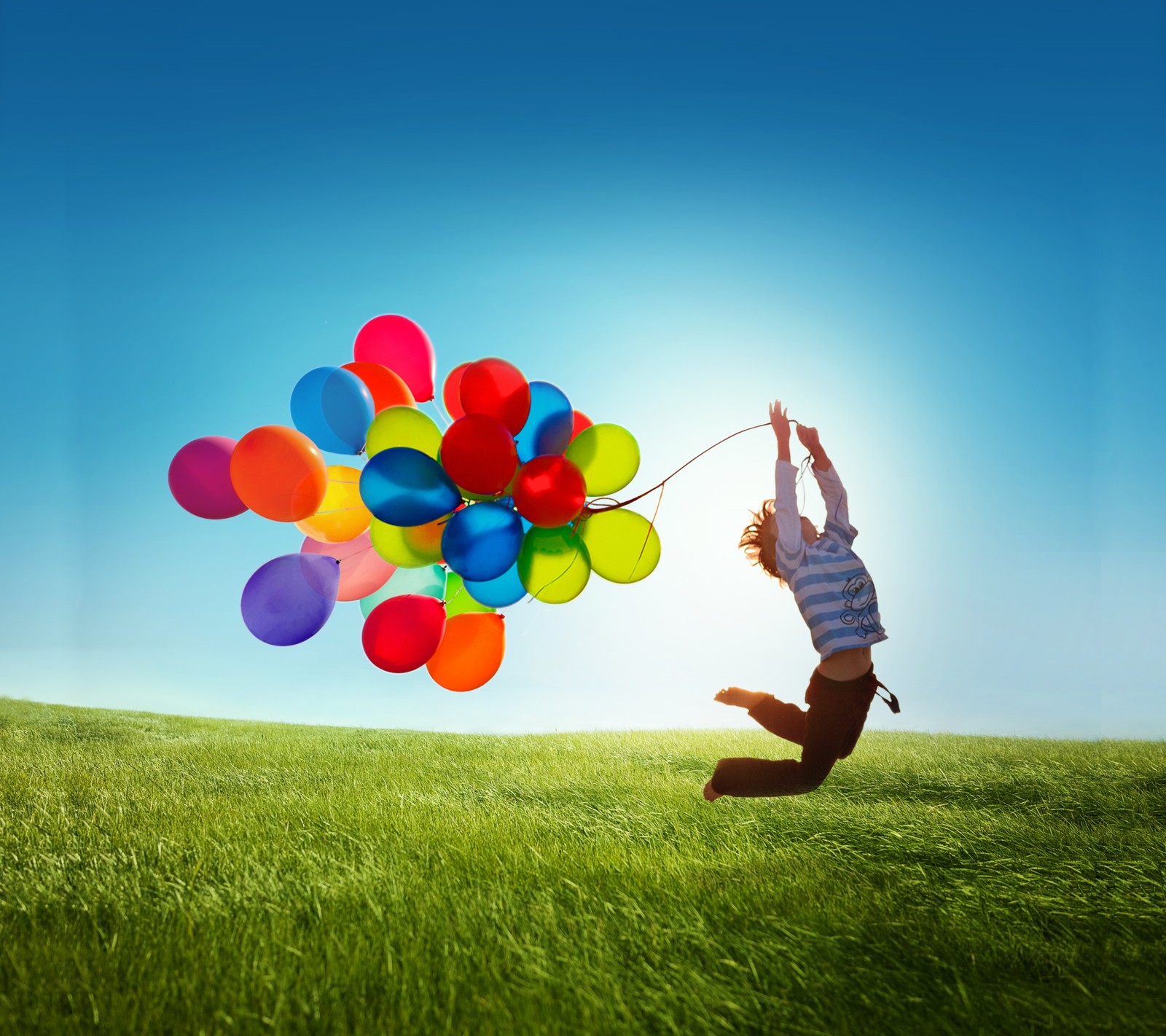 Arafed man jumping in the air with balloons in his hand (balloon, field, galaxy, grass, gs4)