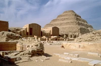 Ruins of an ancient Egyptian pyramid surrounded by archaeological remnants, showcasing the monumental history of the Great Pyramid of Giza.