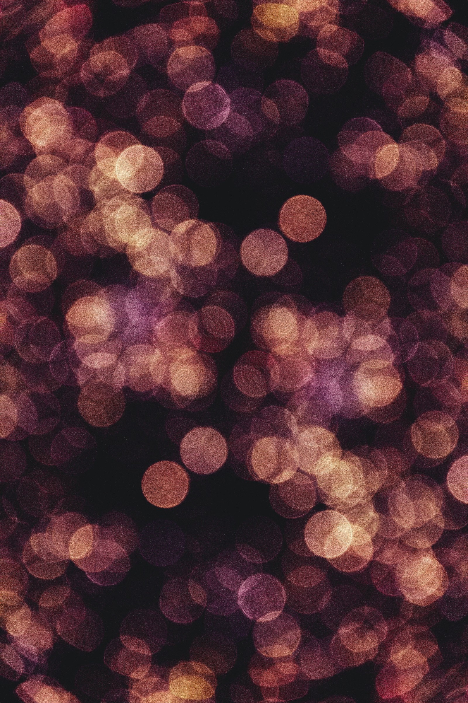 A close up of a bunch of lights that are on a black surface (water, textile, lighting, pink, wood)