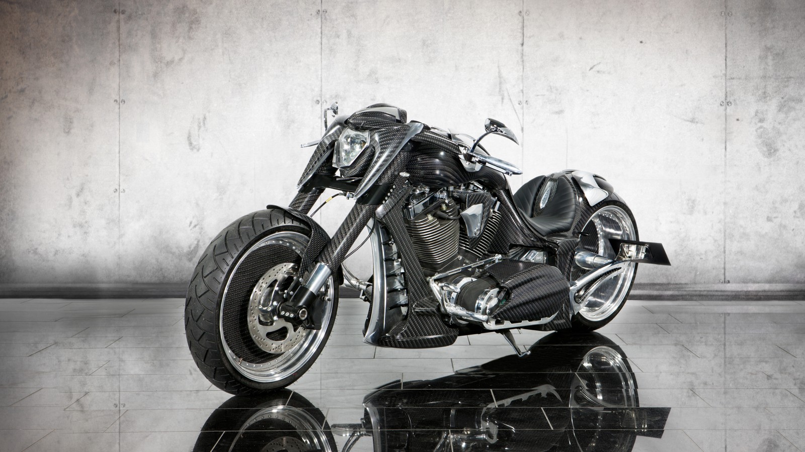 There is a black motorcycle parked in a room with a wall (king, volkswagen group, motorcycle, mansory, wheel)