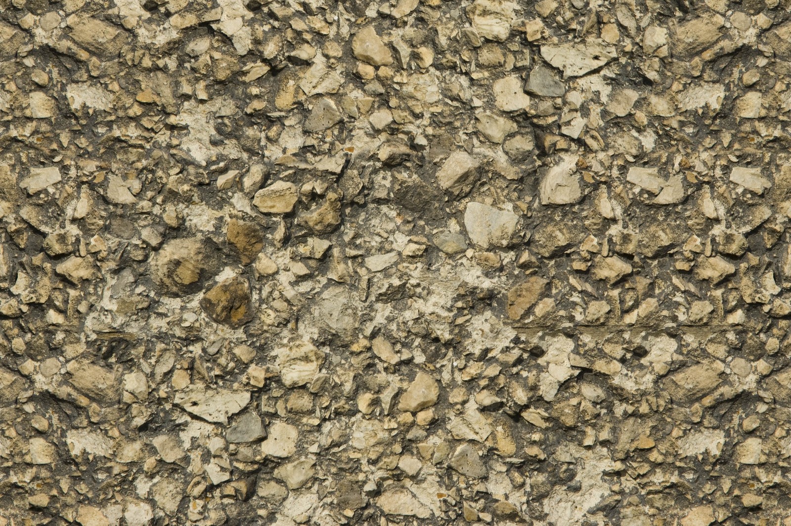 Un primer plano de una pared de rocas con una pequeña cantidad de piedras (muro de piedra, textura, pared, granito, diseño)