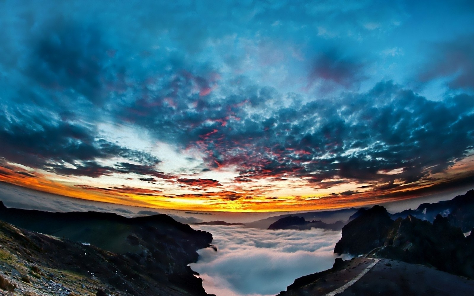 A view of a mountain with a sunset and clouds in the sky (nature, cloud, horizon, atmosphere, dawn)